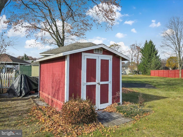 view of outbuilding with a lawn