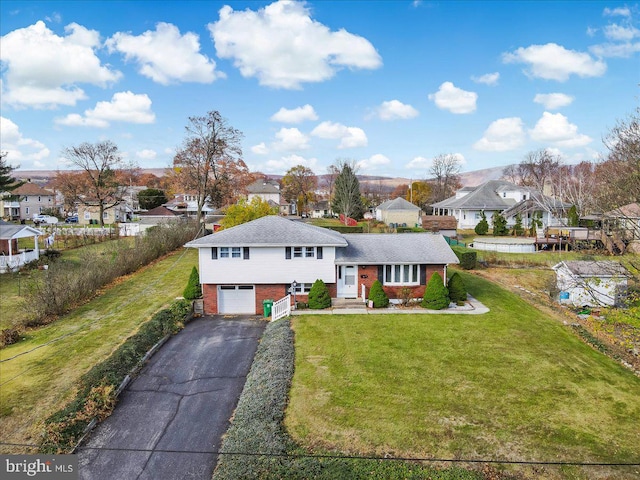 view of front of home featuring a garage and a front lawn