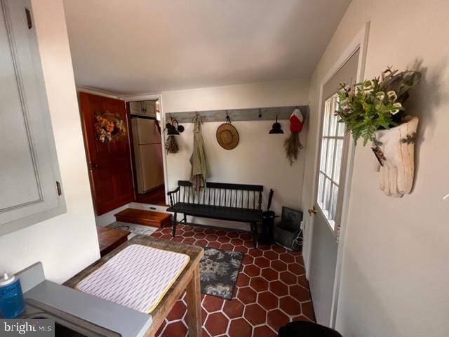 mudroom featuring dark tile patterned flooring