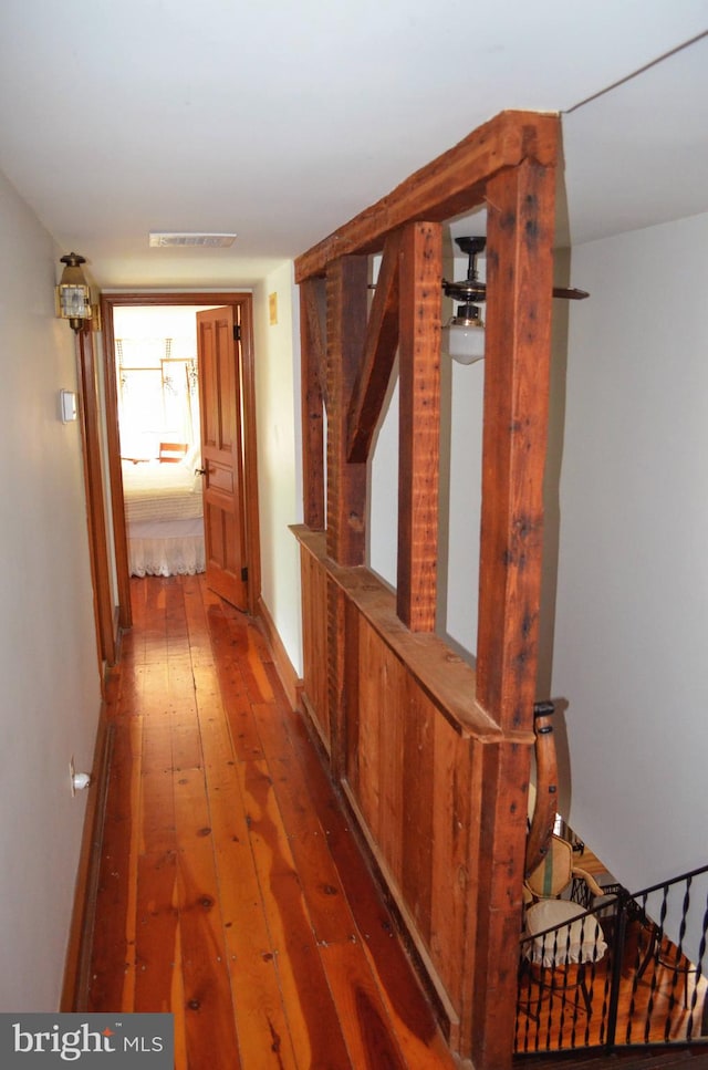 corridor featuring wood-type flooring