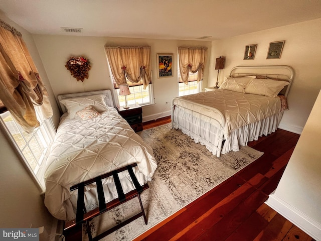 bedroom with dark wood-type flooring