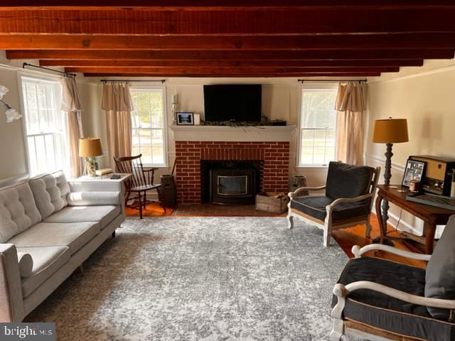 living room featuring a fireplace and beamed ceiling