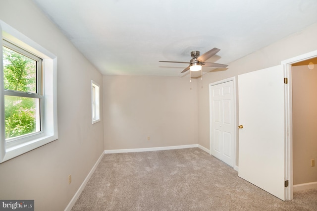 carpeted empty room with ceiling fan