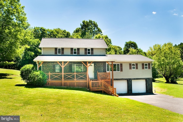 view of front of home featuring covered porch, a front yard, and a garage