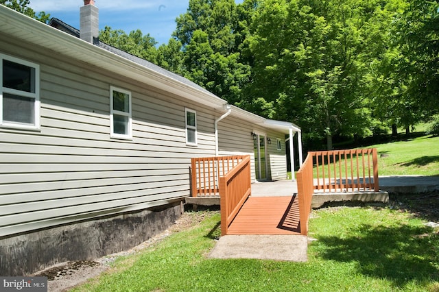 wooden deck featuring a lawn