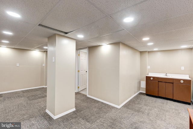 interior space featuring carpet and a drop ceiling