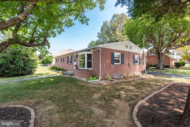 view of front facade with a front yard and central AC unit