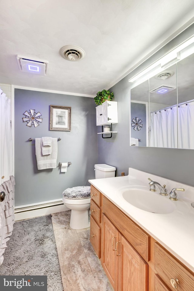 bathroom with tile patterned flooring, vanity, toilet, and a baseboard heating unit