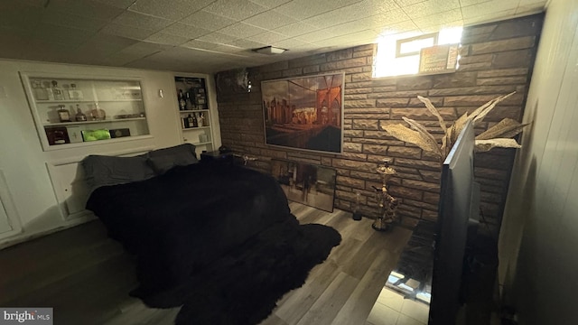 interior space featuring built in shelves and wood finished floors