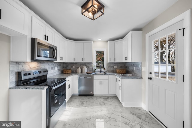 kitchen with white cabinets, backsplash, stainless steel appliances, and sink