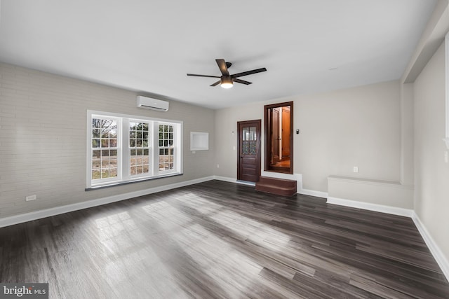 unfurnished living room with a wall unit AC, ceiling fan, and dark hardwood / wood-style floors