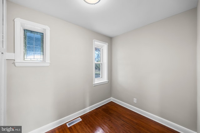 empty room with hardwood / wood-style flooring