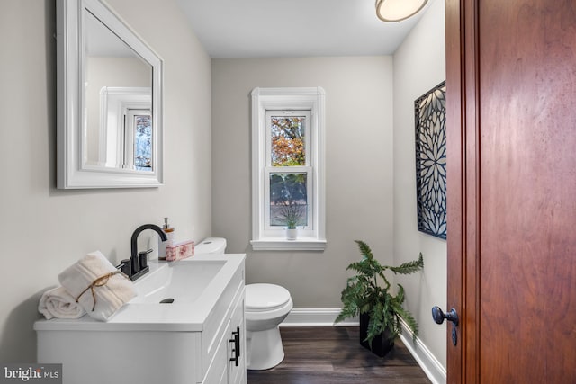 bathroom with vanity, toilet, and wood-type flooring