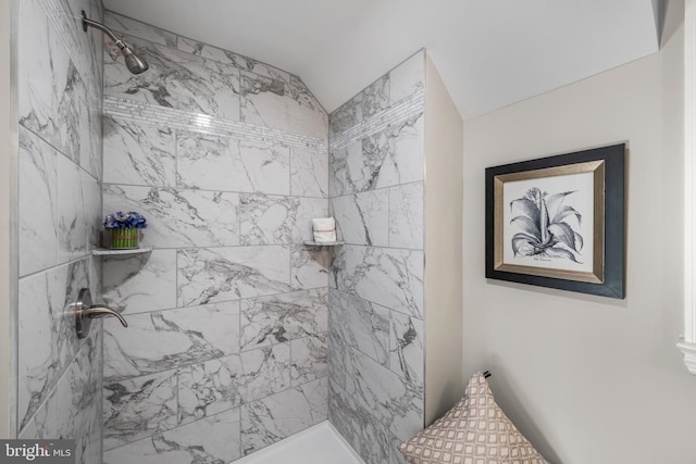 bathroom with tiled shower