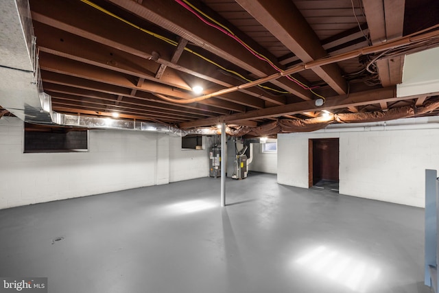 basement featuring heating unit and gas water heater