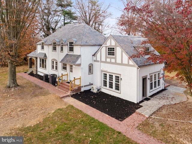 rear view of house with central AC unit and french doors