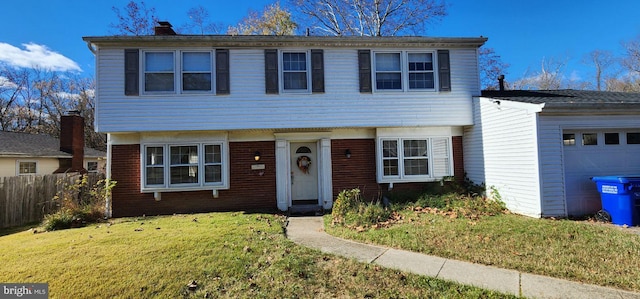 view of front of property featuring a garage and a front lawn