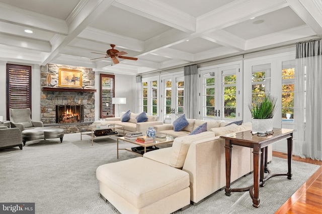 living room featuring coffered ceiling, beam ceiling, wood-type flooring, and french doors