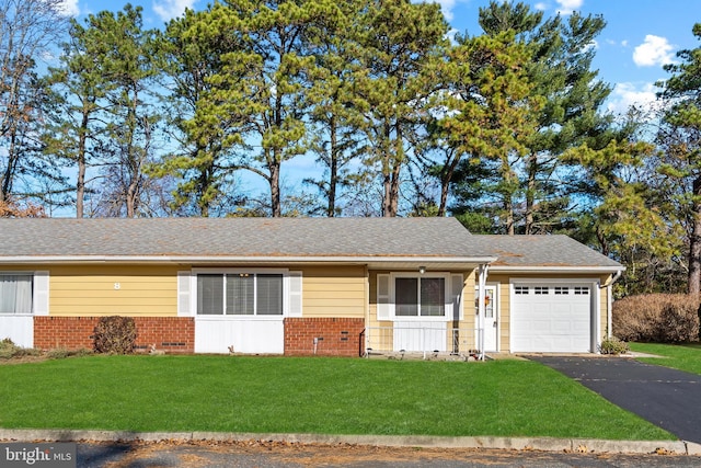 ranch-style home featuring a garage and a front yard