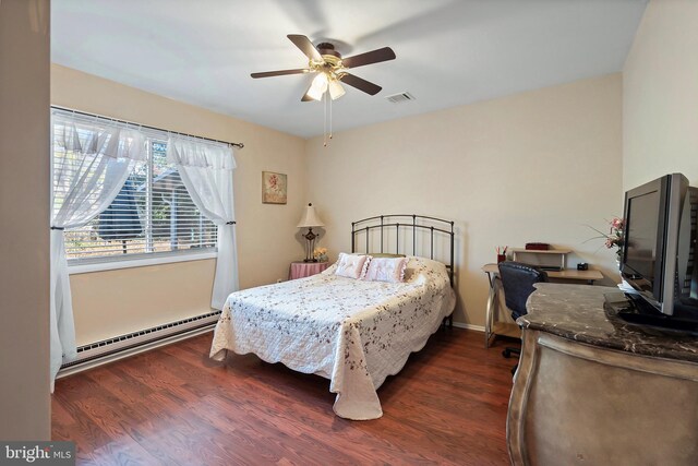 bedroom with ceiling fan, dark wood-type flooring, and a baseboard radiator