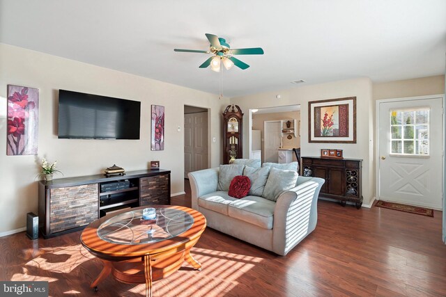 living room featuring dark hardwood / wood-style floors and ceiling fan