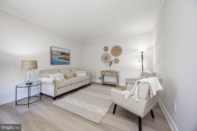 living room with baseboards, ornamental molding, and wood finished floors