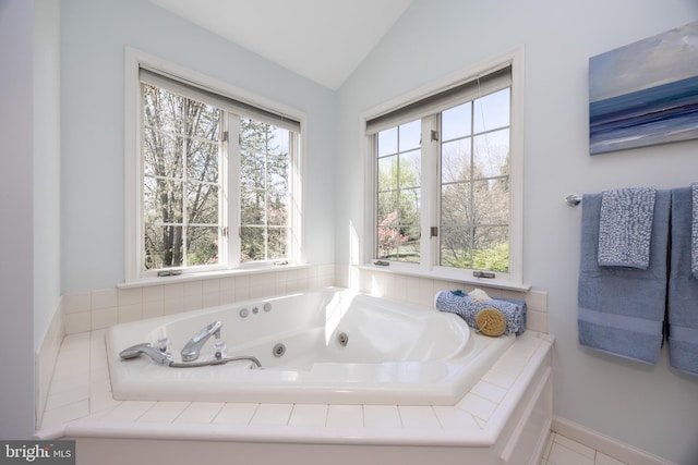 full bathroom with a jetted tub and vaulted ceiling