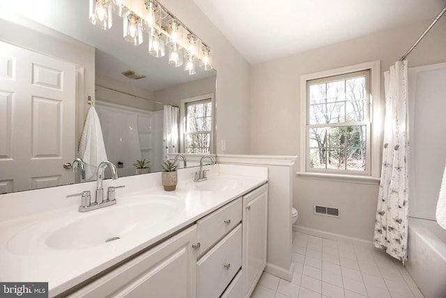 bathroom featuring visible vents, a sink, and toilet