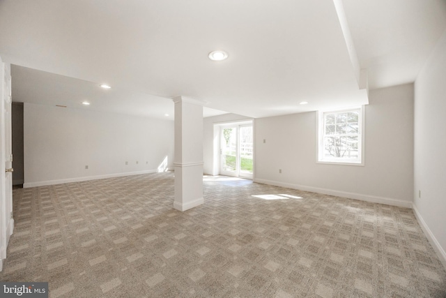 below grade area featuring recessed lighting, baseboards, and light carpet