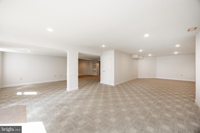 finished basement featuring recessed lighting, baseboards, and light carpet