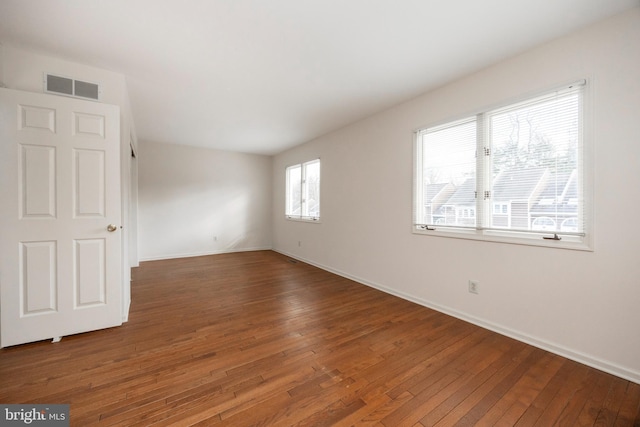 empty room with dark wood-type flooring