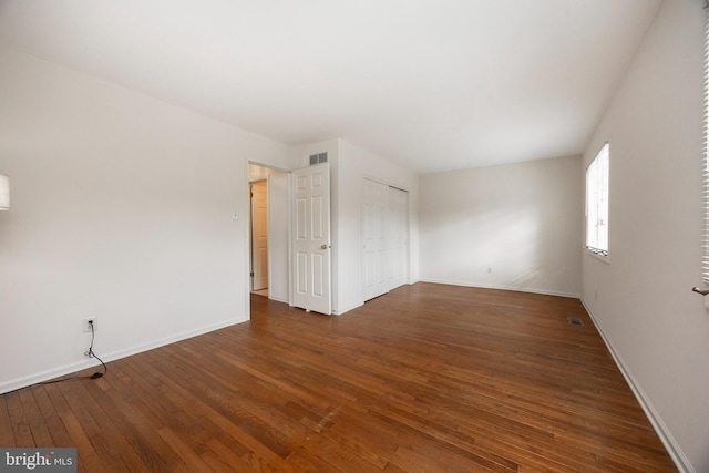 spare room featuring dark wood-type flooring