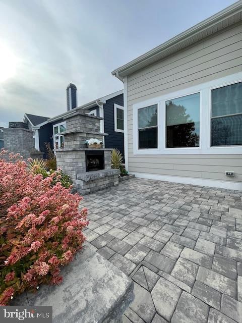 view of patio / terrace featuring an outdoor fireplace