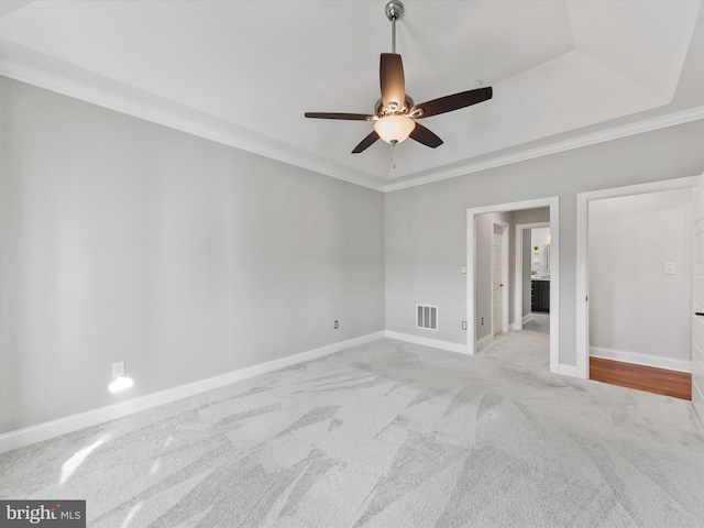 carpeted spare room featuring ceiling fan and ornamental molding