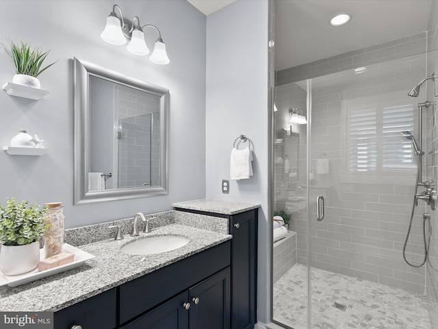 bathroom featuring vanity and walk in shower