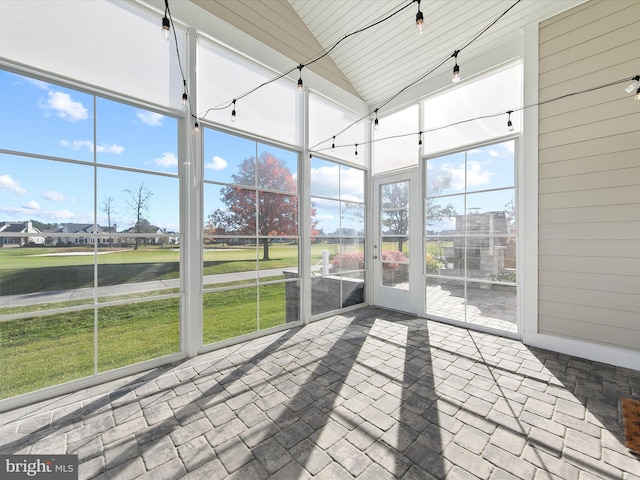 unfurnished sunroom with vaulted ceiling