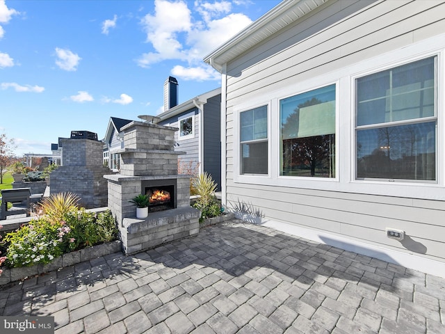 view of patio with an outdoor stone fireplace