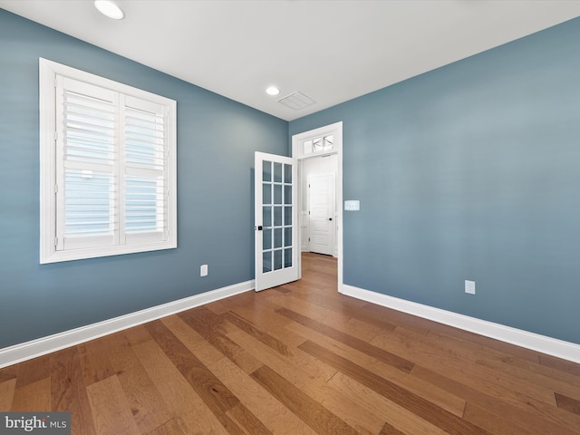 spare room with hardwood / wood-style floors