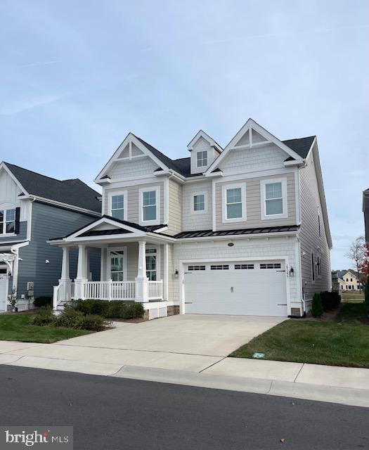 craftsman house featuring covered porch and a garage