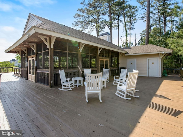 wooden terrace with a sunroom and french doors