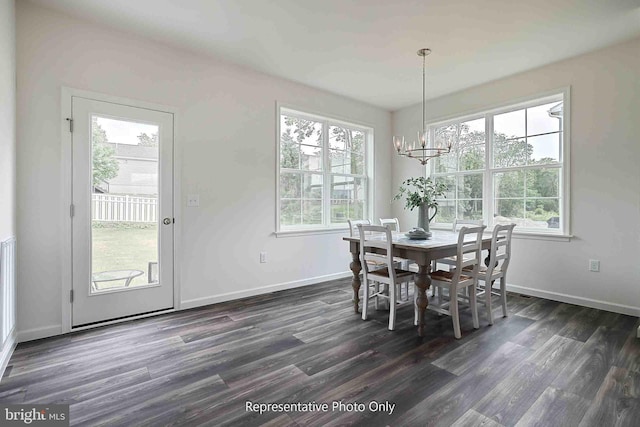 dining space with a chandelier, dark hardwood / wood-style flooring, and a wealth of natural light