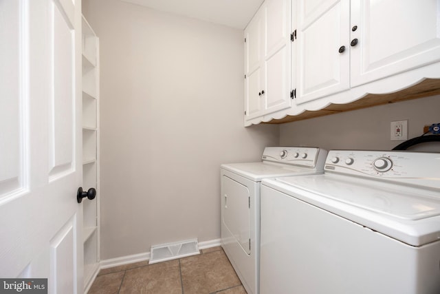 laundry room with light tile patterned floors, baseboards, visible vents, washing machine and clothes dryer, and cabinet space