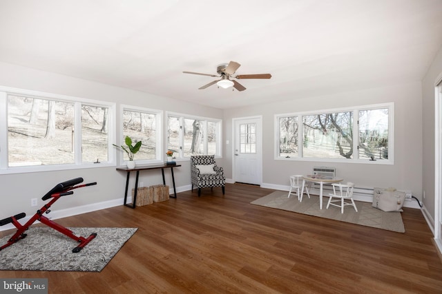 unfurnished room with a healthy amount of sunlight, baseboards, and wood finished floors