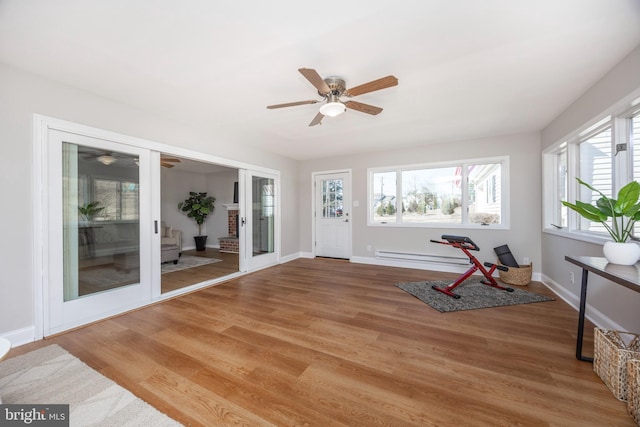 unfurnished sunroom featuring ceiling fan