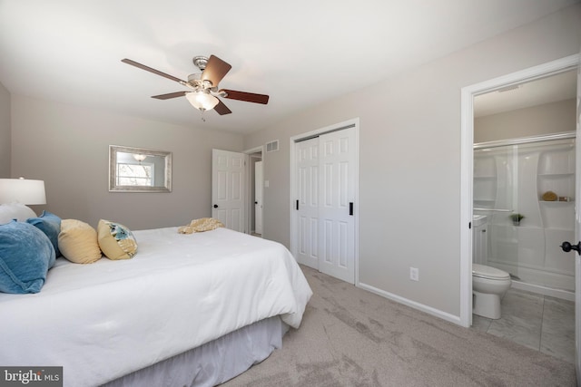 bedroom featuring visible vents, ceiling fan, carpet, baseboards, and ensuite bath