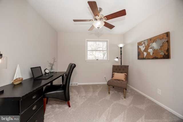 carpeted office with visible vents, ceiling fan, and baseboards