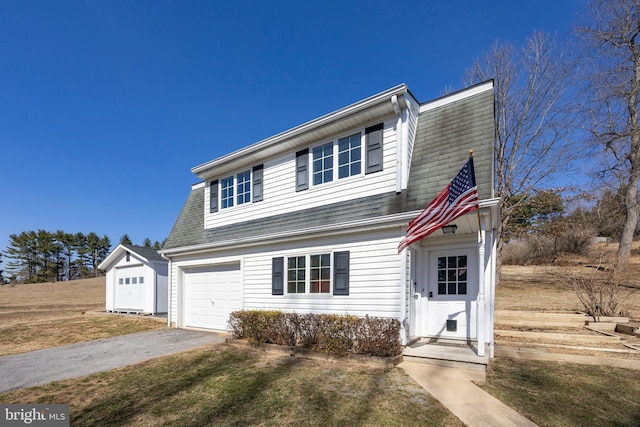 view of front of property with aphalt driveway, an attached garage, and roof with shingles