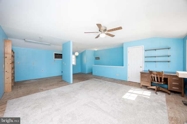 unfurnished office with an AC wall unit, a ceiling fan, and vaulted ceiling