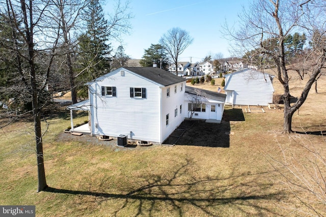 exterior space featuring a lawn and central AC