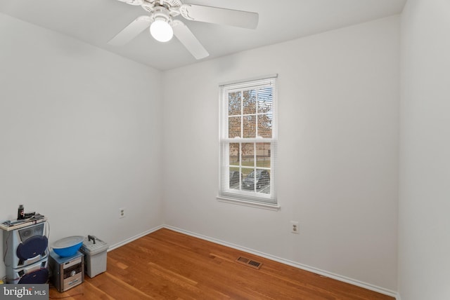 spare room featuring hardwood / wood-style floors and ceiling fan